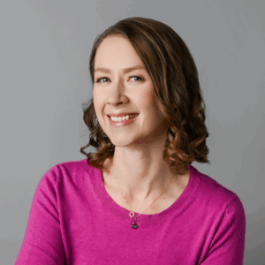 Megan Melo close headshot pink sweater